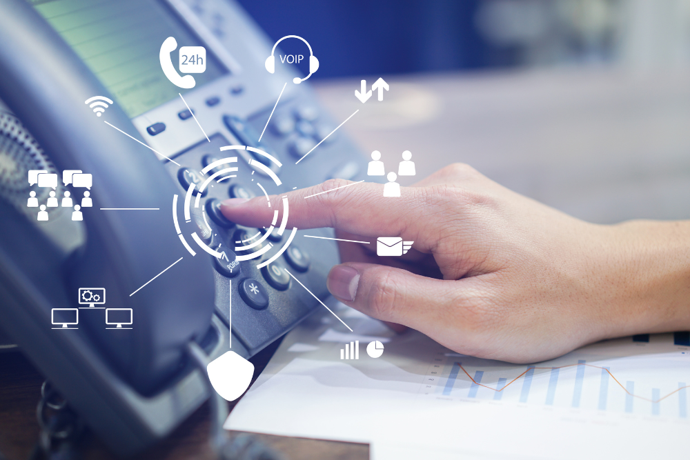 Close-up of a person pressing a button on a VoIP phone, with various icons representing VoIP features and connectivity options.