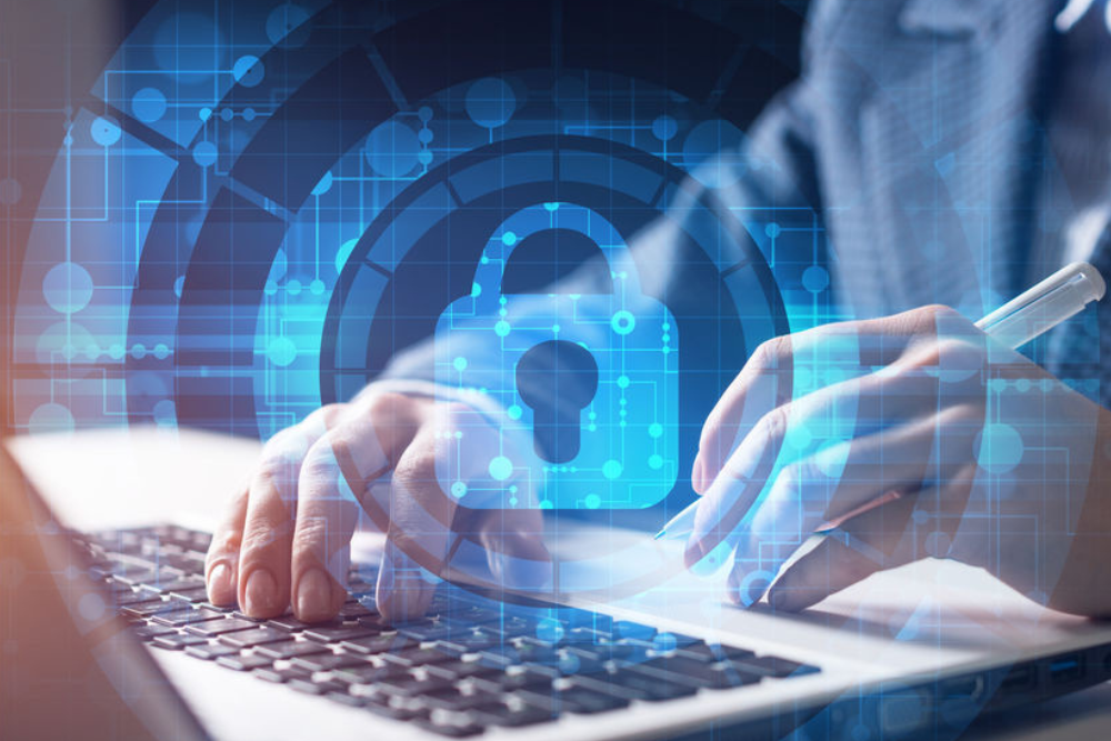 Close-up of a person typing on a laptop keyboard with a digital lock icon and network graphics overlay, symbolizing cybersecurity. This image emphasizes the importance of protecting digital information and maintaining secure networks in a technology-driven world.